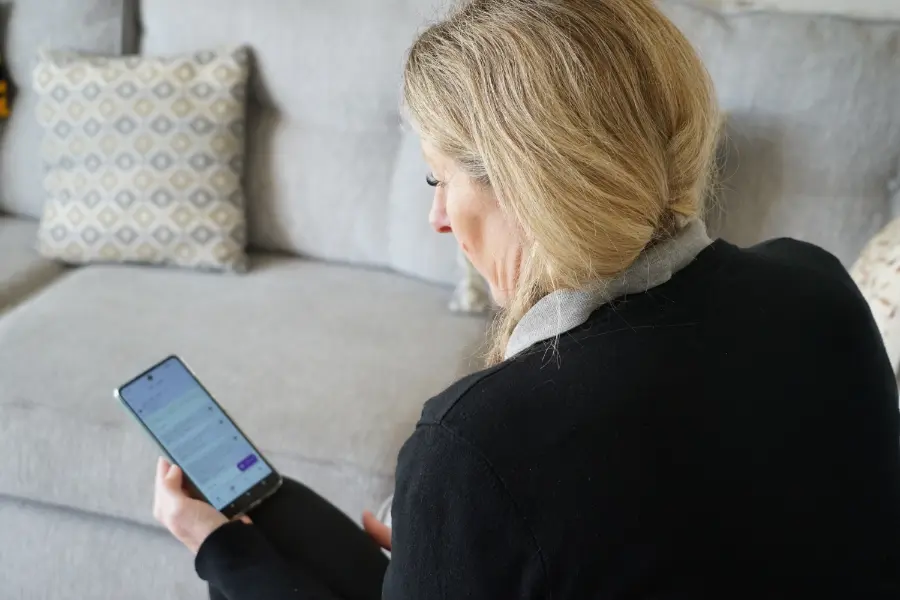 Carer using digital care management app to organise client visits and tasks