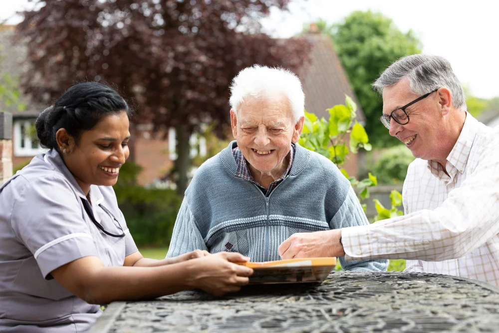 Care staff and elderly resident sharing a moment – compassionate care team in action